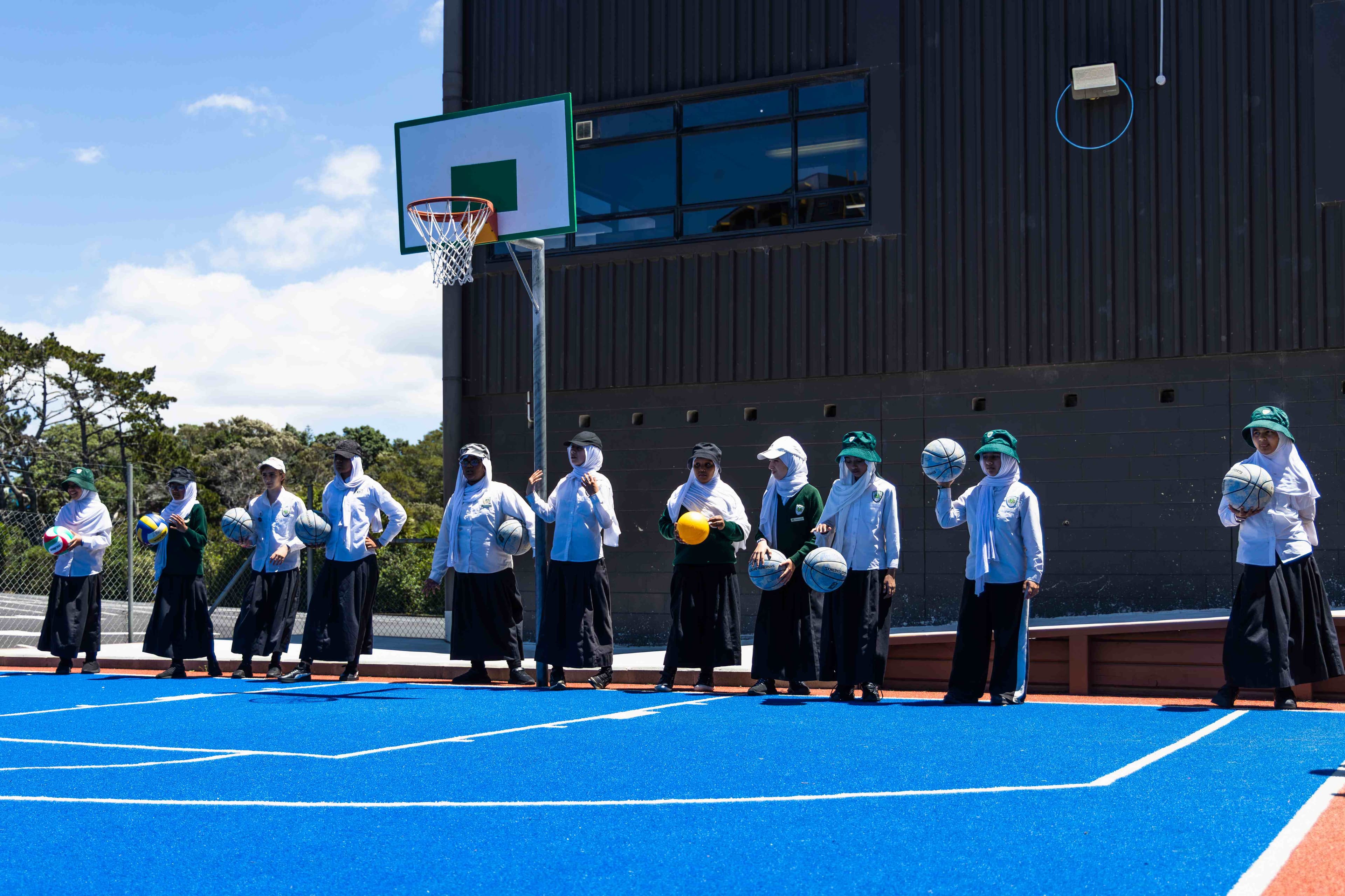 Students from Iqra School holding basketballs