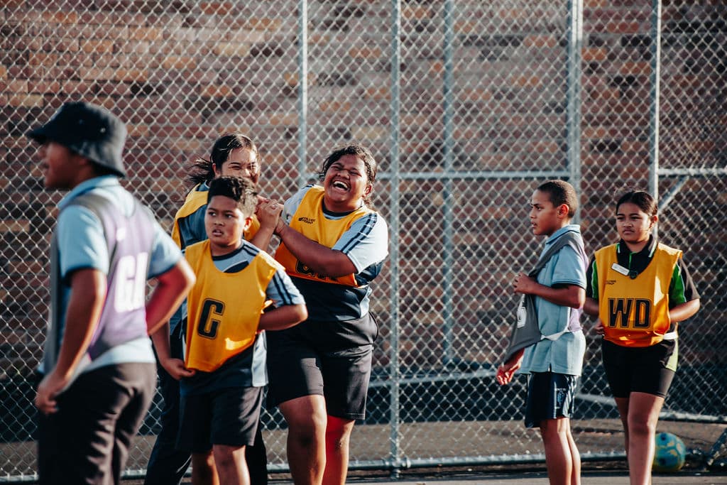 Young athletes celebrating during a community sport event in West Auckland