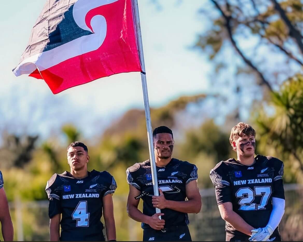 Players wave Tino Rangatiratanga flag on sideline at West Auckland football festival